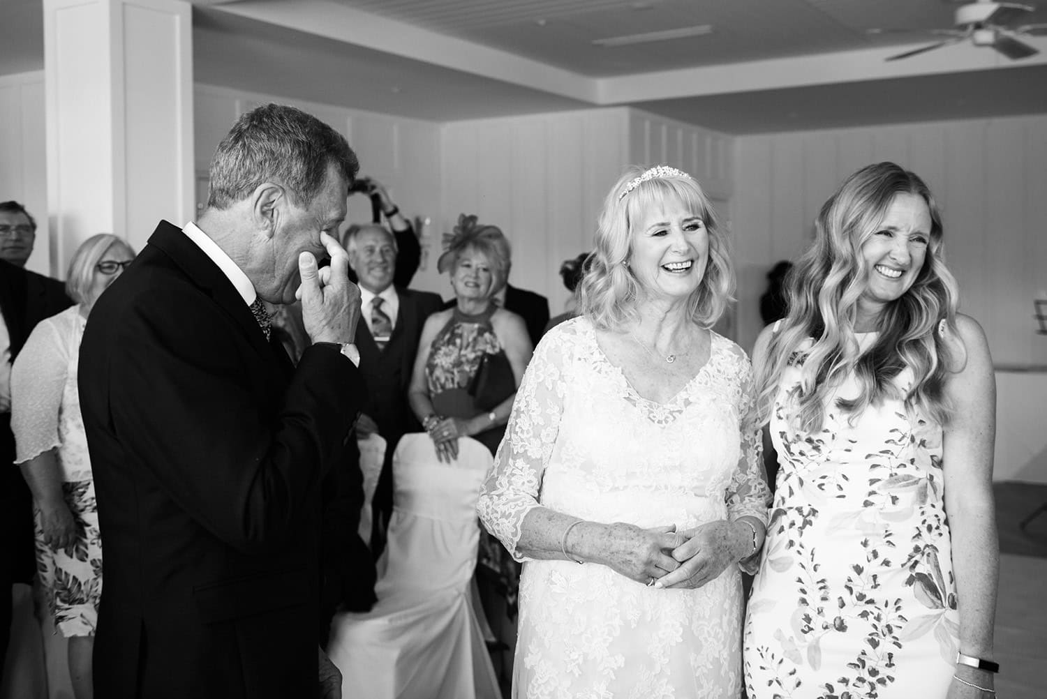 groom crying during the ceremony in black and white