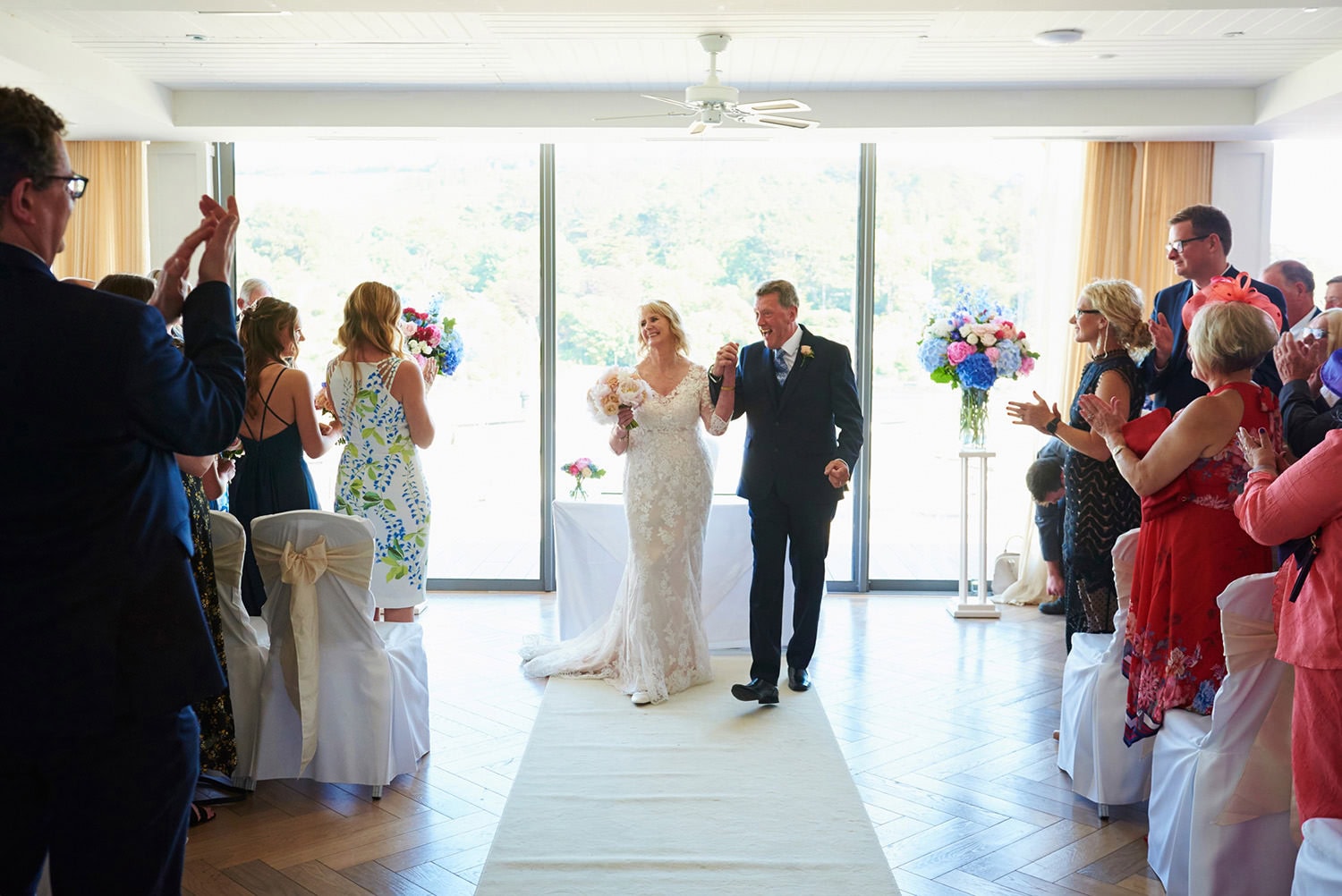 mature bride and groom just married and full of smiles walking back up the aisle