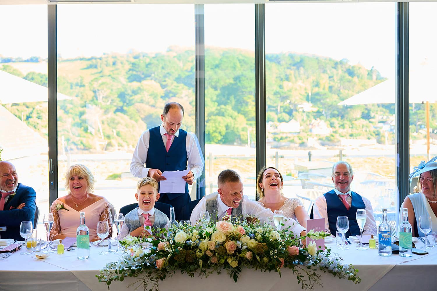 bride and groom and guest laughing during speeches