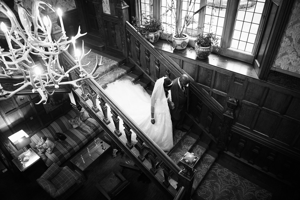 Bride and Dad walking donw staircase at Bovey Castle