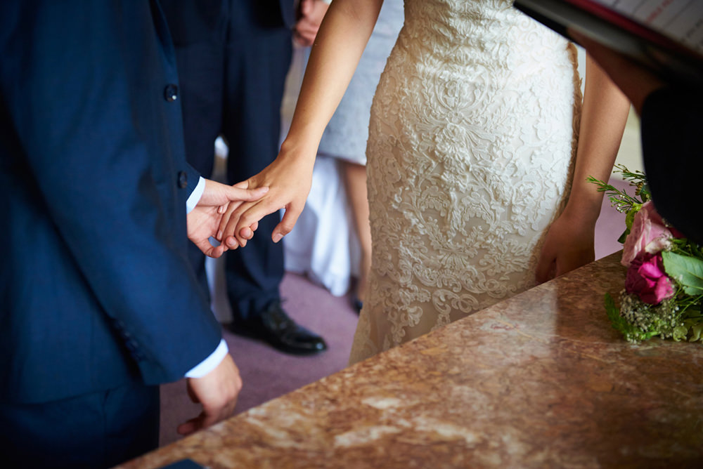 bride and groom touching hands