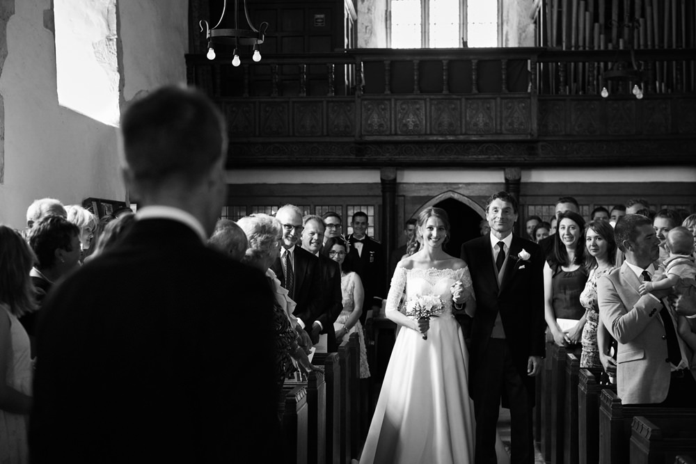 dad walking bride down the aisle inside church