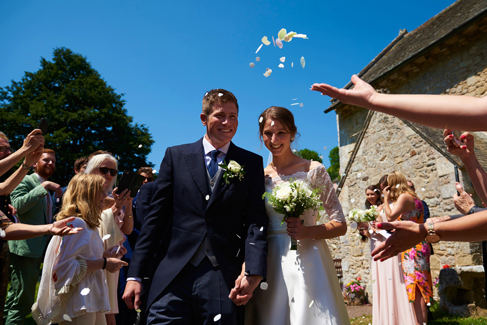 confetti being thrown over bride and groom