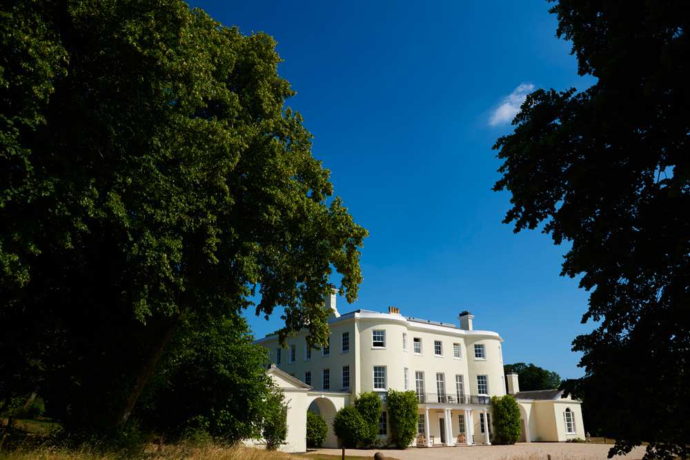 Rockbeare Manor and blue sky with trees