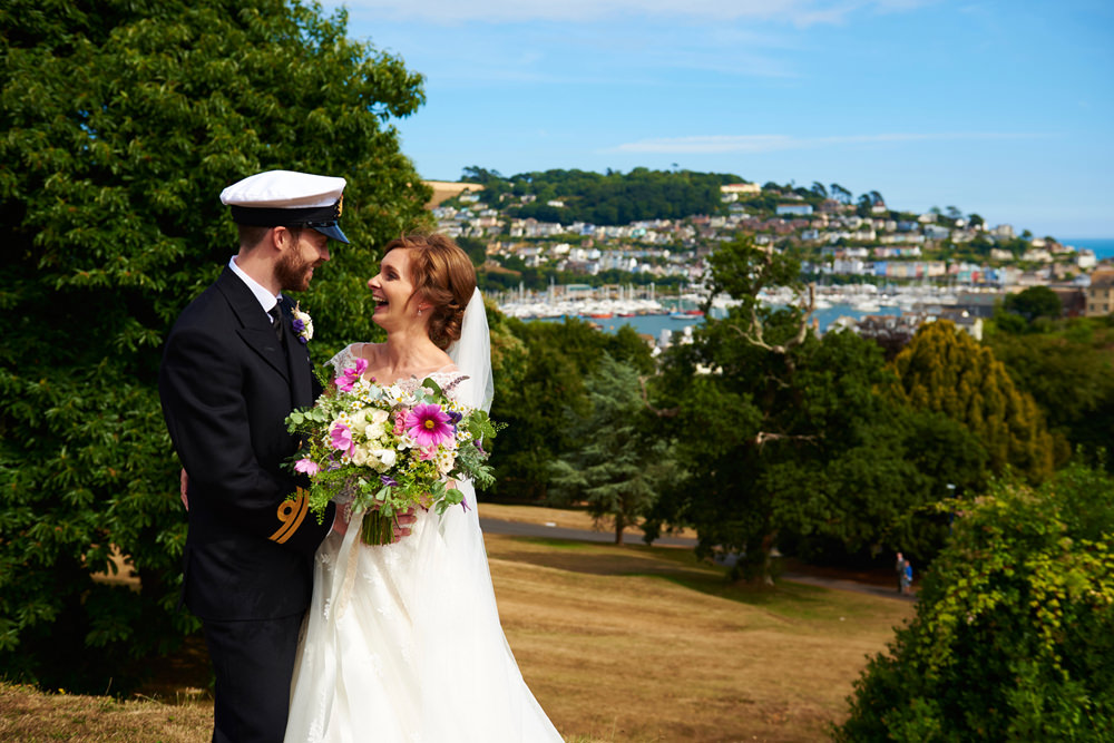 close up of bride and groom with Dartmouth in background