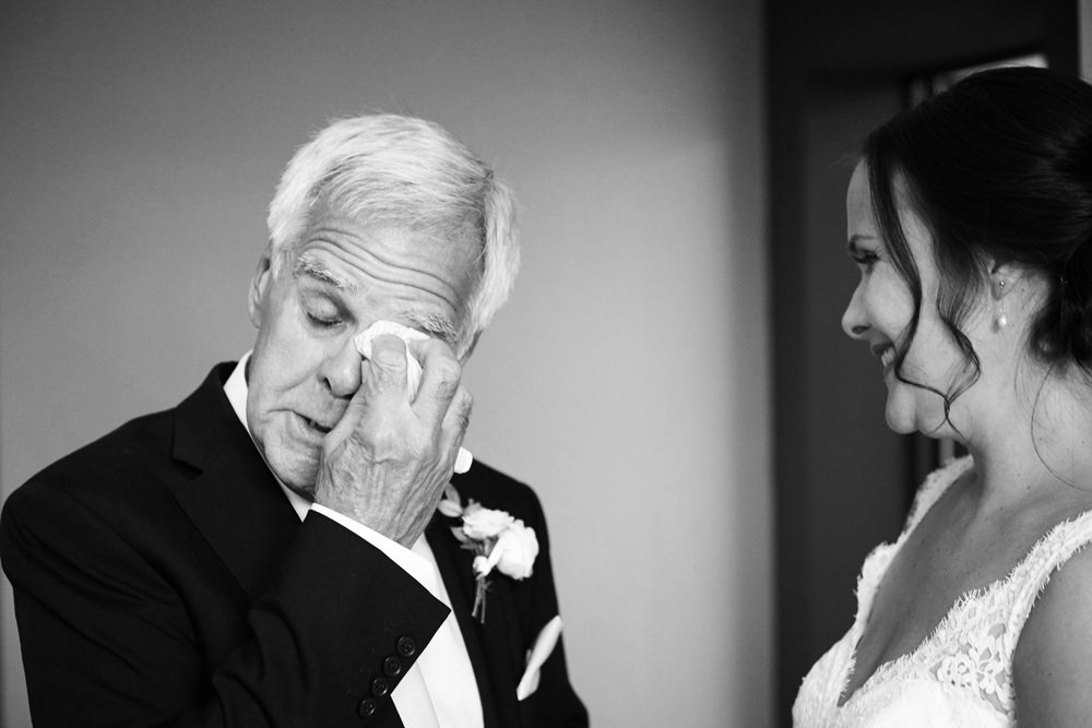 father of bride crying after seeing daughter in dress