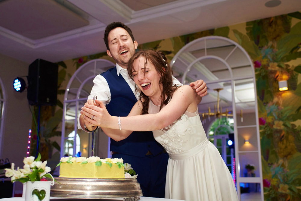 cutting the cake in a very relaxed way with lots of laughter