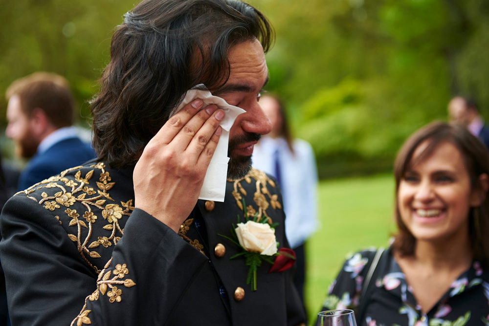 indian groom crying with tissue