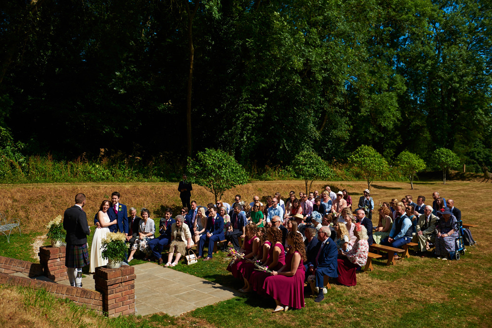 a reading during the outside ceremony wide shot with all guests