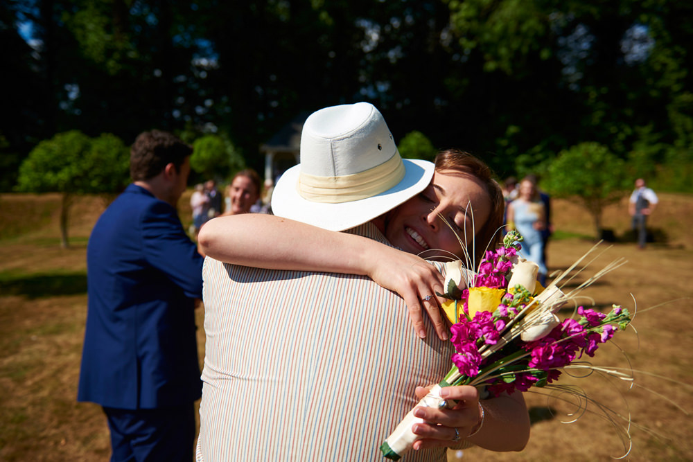 guests hugging bride
