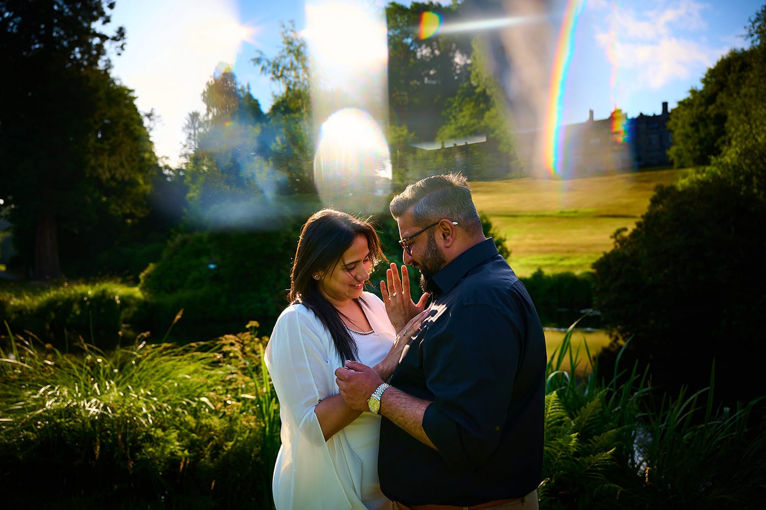 Proposal in Devon at Bovey Castle- bride and groom hugging in beautiful backlit sunlight
